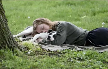  ?? Pittsburgh Post-Gazette ?? A woman and her dog nap between rain showers at Schenley Park in Oakland in May 2021. A Gallup poll released Monday says that a majority of Americans say they would feel better if they could get more sleep.