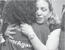  ?? Joe Raedle / Getty Images ?? Rep. Debbie Wasserman Schultz, D-Fla., hugs Tyah-Amoy Roberts, a junior at Marjory Stoneman Douglas High School who survived the shooting on Valentine's Day that killed 17.