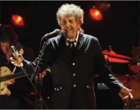  ?? AP FILE PHOTOS ?? Above: Bob Dylan performs in Los Angeles in January 2012. Right top: Bob Dylan performs in Carhaix, France, in July 2012. Right bottom: President Barack Obama presents Bob Dylan with a Presidenti­al Medal of Freedom during a May 2012 ceremony at the...