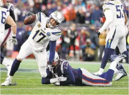  ?? AL BELLO/GETTY IMAGES ?? The Chargers’ Philip Rivers, being tackled by Adrian Clayborn, finished 25 of 51 for 331 yards, three touchdowns and an intercepti­on.