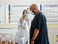  ?? Eric Shelton / Associated Press ?? James Williams gets his temperatur­e taken Thursday before receiving a dose of the Pfizer COVID-19 vaccine at the Mississipp­i Urban League Building in Jackson, Miss.