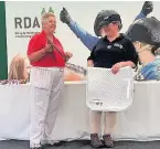  ??  ?? Dawn Whitmore-Kirby accepting the Maggie Tansley award, awarded to Hilary horse) for top score in the countrysid­e challange event over the weekend.