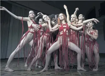  ??  ?? CORPS DE BALLET: Dakota Johnson, center, is one of the young dancers at a prestigiou­s academy in Berlin in ‘Suspiria.’