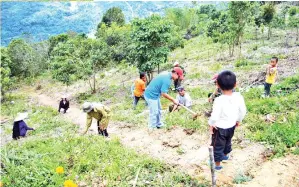  ??  ?? PENDUDUK kampung bergotong-royong membina anak tangga sejauh 100 meter menuju ke gunung itu.