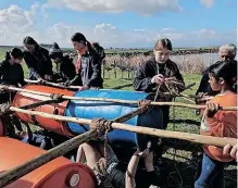  ?? L SUPPLIED ?? GIRL Guides hard at work building a raft.