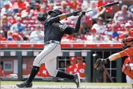  ?? John Minchillo ?? The Associated Press Braves rookie Ronald Acuna Jr. follows through on a go-ahead RBI double in the eighth inning of Atlanta’s 7-4 win over the Reds on Thursday at Great American Ball Park.