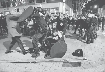  ??  ?? Riot police clash with demonstrat­ors in the streets near the Turkish consulate in Rotterdam. — Reuters photo