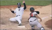  ?? KATHY WILLENS - THE ASSOCIATED PRESS ?? New York Yankees Clint Frazier, left, is safe scoring ahead of the tag by Baltimore Orioles catcher Pedro Severino (28) on pinch-hitter Gleyber Torres’s two-run double during the eighth inning of a baseball game, Sunday, Sept. 13, 2020, at Yankee Stadium in New York.