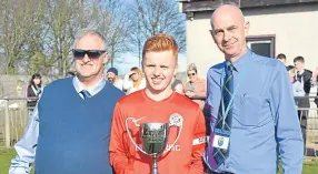  ??  ?? Tayport U/19s captain Fraser Anderson receives the J Cord Cup from DDYFA officials Jim Falconer (left) and Fraser Mortimer.