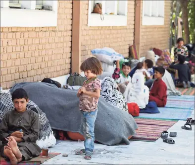  ?? Wakil Kohsar/AFP / TNS ?? Internally displaced Afghan families, who fled from the northern province due to battle between Taliban and Afghan security forces, sit in the courtyard of the Wazir Akbar Khan mosque in Kabul on Aug. 13.