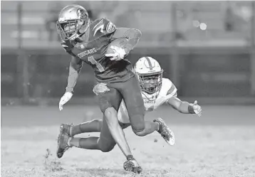  ?? MICHAEL LAUGHLIN/SUN SENTINEL ?? Coconut Creek’s Trevell Mullen shakes off Plantation’s DJ Hall during the first half of their game on Nov. 19. Mullen was one of three local players who participat­ed in the All-American Bowl in San Antonio on Saturday.