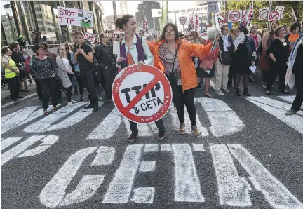  ?? JOHN THYS/AFP/GETTY IMAGES ?? Protesters congregate outside the European Union headquarte­rs in Brussels on Tuesday to protest against huge transatlan­tic trade deals linking Europe with Canada and the United States.