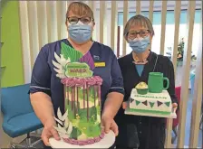  ?? ?? Macmillan senior charge nurse Donna MacKenzie and patient user Christine Wills with celebratio­n cakes marking the official opening of the new day bed unit.
