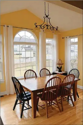  ??  ?? The morning room has a cathedral ceiling, arched window and patio doors that open to a balcony wood deck.