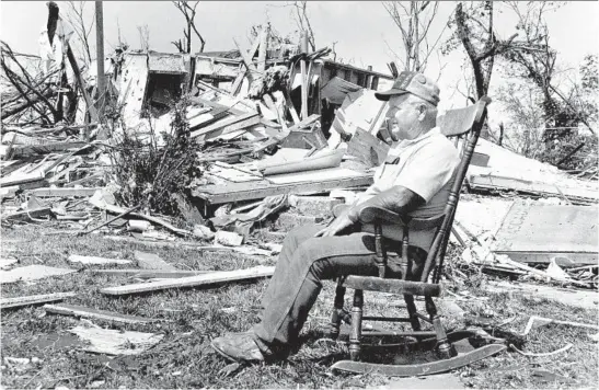  ?? DON CASPER/CHICAGO TRIBUNE ?? John Lee of the Lily Cache subdivisio­n sits in his rocking chair on Aug. 29, 1990, and surveys damage done by the tornado that devastated Plainfield the day before.