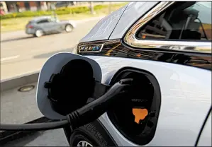  ?? Bloomberg News ?? A Chevrolet Bolt charges up outside the General Motors complex earlier this year in Detroit. GM says it will ask the federal government for one national gas-mileage standard, including a requiremen­t that a percentage of auto sales be zero-emissions vehicles.