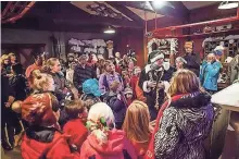  ??  ?? Children learn how Santa keeps his overnight delivery service humming during a tour at the North Pole Experience.