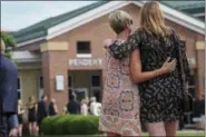  ?? BRYAN WOOLSTON — THE ASSOCIATED PRESS ?? Mourners embrace as they arrive for the funeral of Otto Warmbier, Thursday in Wyoming, Ohio.