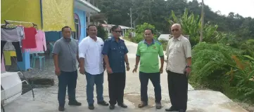  ??  ?? Jamit (centre), Garai (second right) and his service centre staff at Lorong Masam, Simpang 4, Pelajau.