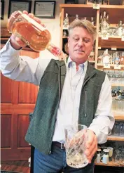  ??  ?? Colin Keegan, owner of Santa Fe Spirits, pours a glass of apple brandy at its downtown tasting room Tuesday.