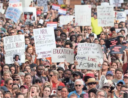  ?? JOE RONDONE/USA TODAY NETWORK ?? Marjory Stoneman Douglas High School students lead the way Wednesday at a rally against gun violence on the steps of the Old Capitol in Tallahasse­e. Similar rallies were held around the USA in solidarity.