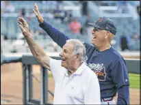  ?? CURTIS COMPTON / CCOMPTON@ AJC.COM ?? Former Braves manager Bobby Cox (front) joins the festivitie­s, waving to fans with current skipper Brian Snitker.