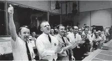  ?? AP ?? NASA’s Gerald Griffin, left, Eugene Kranz, Glynn Lunney and Milton Windler celebrate after bringing the craft back to Earth.