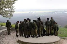  ?? (Reuters) ?? ISRAELI SOLDIERS stand in a circle in the Golan.