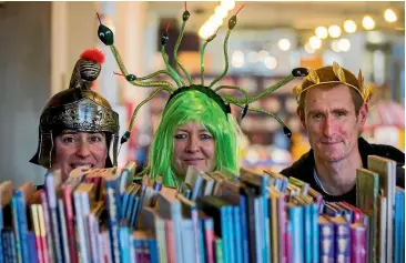  ?? DAVID UNWIN/FAIRFAX NZ ?? Library staff Rhonda Chenery, Helen Dailey and Alan Dingley, preparing for a night of storytelli­ng about the superheroe­s of Greek myth. Photo: