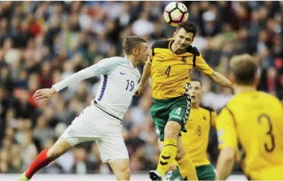  ?? — AP ?? LONDON: England’s Jamie Vardy, left, and Lithuania’s Tadas Kijanskas challenge for the ball during the World Cup Group F qualifying soccer match between England and Lithuania at the Wembley Stadium in London, Great Britain, yesterday.