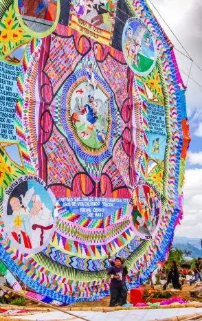  ?? PHOTOS: © LUCY BROWN | DREAMSTIME.COM, © KERTU SAARITS | DREAMSTIME.COM ?? Crowd Pleasers:
Giant kite at All Saints Day festival in Guatemala (top), and a young man with his camel in the desert during Al Dhafra Festival