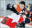  ?? — PNG ?? Jordan Martinook (left) takes on Tyler Hansen of the Kamloops Blazers.