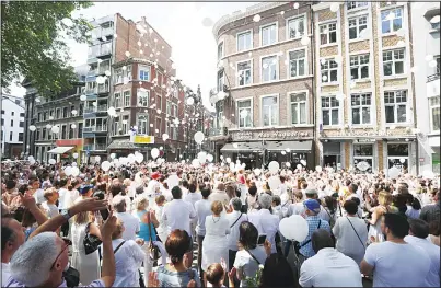  ?? (AFP) ?? People take part in a white march to commemorat­e the victims of a shooting on May 29 in Liege, at the Tivoli space, in Liege city center on
June 3.