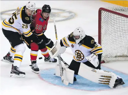  ?? COLOR CHINA, VIA THE ASSOCIATED PRESS ?? Brandon Carlo, left, and goalie Jaroslav Halak of the Boston Bruins and Derek Ryan of the Calgary Flames battle for the puck during an exhibition game in Shenzhen in southern China’s Guangdong province on Saturday. Boston won 4-3 in a shootout.