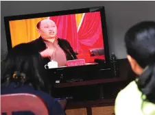  ?? — AFP photo ?? File photo shows Zheng, speaking on television as villagers watch the broadcast in Wukan, Guandong province, where residents demanded the government take action over illegal land grabs and the death in custody of a local leader.