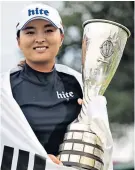  ??  ?? Winning smile: Ko Jin-young shows off the Evian Championsh­ip trophy