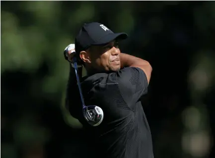  ?? Sam Greenwood, Getty Images ?? Tiger Woods plays a shot during a practice round prior to The Memorial Tournament at Muirfield Village on Tuesday.