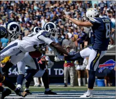  ?? AP Photo/MArK J. terrIll ?? Los Angeles Rams linebacker Cory Littleton blocks a punt by Los Angeles Chargers punter Drew Kaser in the end zone during the first half in an NFL football game on Sundayin Los Angeles.