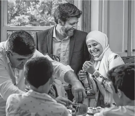  ?? DARREN CALABRESE ?? Tareq Hadhad and his family gather in their kitchen in Antigonish. The Syrian-born founder of Peace By Chocolate is featured in the new free, downloadab­le cookbook Tastes from Home: Recipes from the Refugee Community.