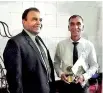  ??  ?? A M Abeykoon receives the award for longest service period within the university from Vice Chancellor Upul B Dissanayak­e