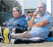  ??  ?? MUSIC AND FUN: Dale and Mark Salida enjoy a relaxed Saturday at the Ellies Electronic­s Mannville Music Festival at St George’s Park