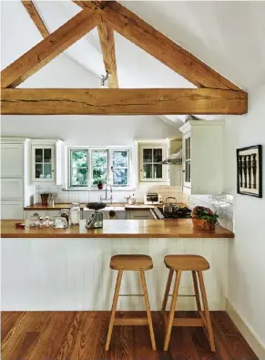  ??  ?? The kitchen Another Country bar stools are lined up at the breakfast bar, their design contrastin­g with that of the framed Florentine furniture legs that hang on the wall beside them.
The snug Each family member has their own seat in front of the...