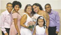  ?? LATISHA OZUNA/WENDY GOMEZ VIA AP ?? This August 2017 photo shows Wendy Gomez, fourth from left, with her wife, Wilnelia Cruz-Ulloa, third from left, with their children and stepchildr­en at their wedding in New York. Cruz-Ulloa spent the last months of her life in a New York City ICU, waiting for a donated liver that never came.