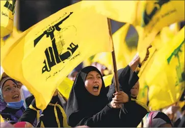  ?? HUSSEIN MALLA Associated Press ?? HEZBOLLAH supporters at a rally in Beirut last week. After Lebanon’s civil war ended in 1990, Hezbollah was the only group officially allowed to keep its weapons because it was fighting Israeli forces in south Lebanon.