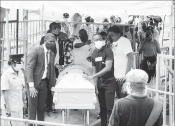  ??  ?? The casket of one of the teens being removed by pallbearer­s from the farewell service at Parade Ground.