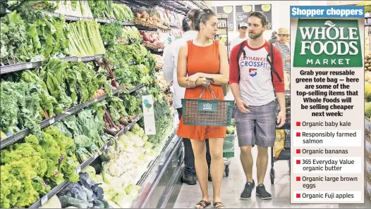  ??  ?? WELL, AISLE BE! Whole Food shoppers, like these Harlem customers, will enjoy cheaper prices next week following the acquisitio­n by Amazon.