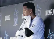  ?? LYNNE SLADKY/AP ?? Marlins starter Jordan Yamamoto sits in the dugout after pitching against the Phillies on Saturday in Miami. Yamamoto is suffering from a strained right forearm and has been put on the 10-day IL.