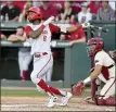  ?? ASSOCIATED PRESS FILE PHOTO ?? North Carolina State’s Jose
Torres (8) watches the ball after connecting for a home run against Arkansas in the ninth inning during an NCAA college baseball super regional game in Fayettevil­le, Ark.