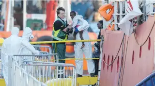  ?? MATTHEW MIRABELLI / AFP / GETTY IMAGES ?? A migrant child gets assistance upon their arrival aboard Lifeline, a vessel for the German charity Mission Lifeline, in Valletta, Malta, on Wednesday.