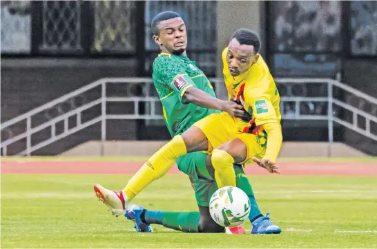  ?? Picture: AFP ?? ROADBLOCK. Zimbabwe’s Khama Billiat (right) fights for the ball with Bafana’s Teboho Mokoena during their World Cup qualifier at the National Sports Stadium in Harare yesterday.